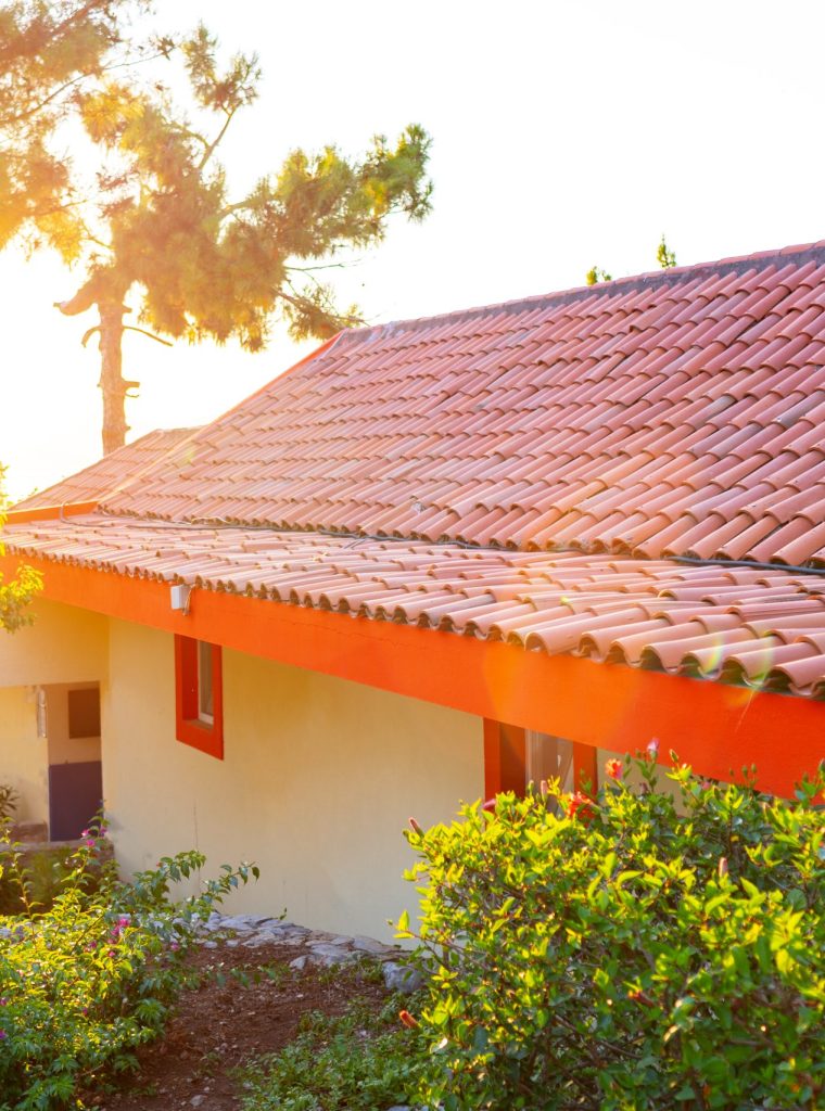 Little house with red terracotta roof tiles close up
